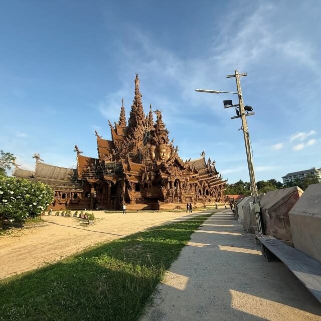 Sanctuary of Truth Holzbauwerk mit aufwendigen Schnitzereien und Weg im Außenbereich unter blauem Himmel