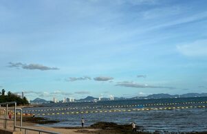 Ruhiger Strandabschnitt bei Jomtien Dongtan Beach mit ruhigem Küstenabschnitt, Meer und Blick Richtung Pattaya