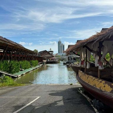 Wasserweg mit Holzgebäuden und Booten zwischen den Marktbereichen